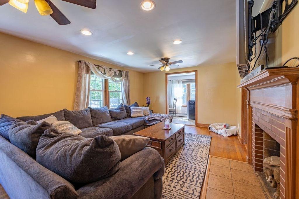 32 Maple Avenue Rutland, MA 01543 - Photo 16 of 42 a living room with furniture a fireplace and a floor to ceiling window