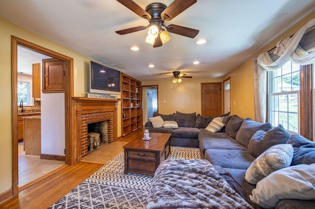 32 Maple Avenue Rutland, MA 01543 - Photo 17 of 42 a living room with furniture a fireplace and a chandelier