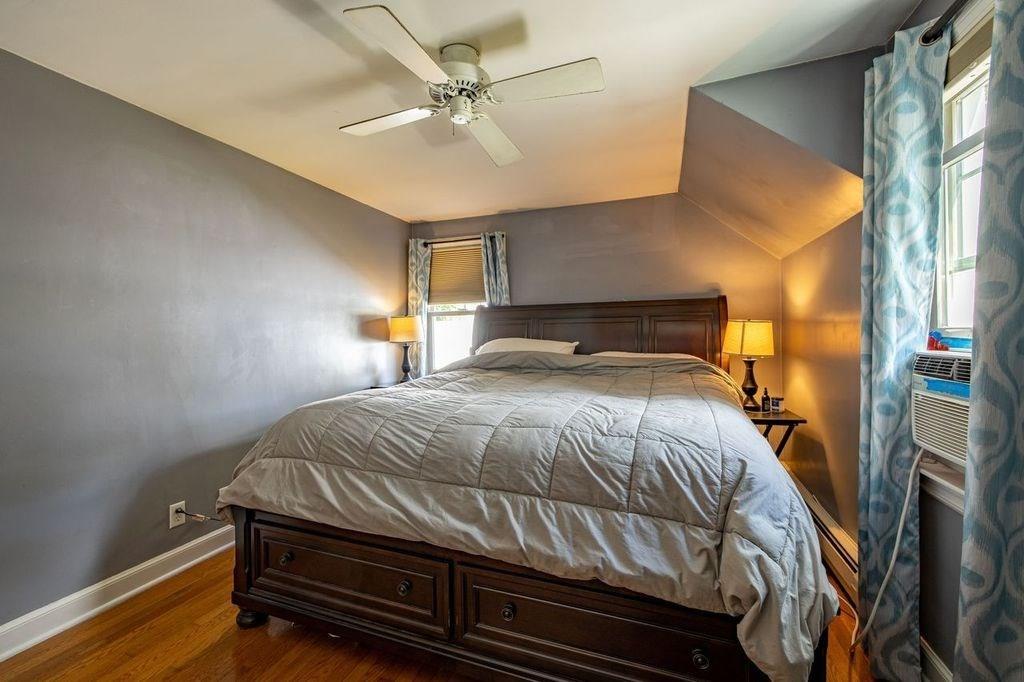 32 Maple Avenue Rutland, MA 01543 - Photo 22 of 42 a bedroom with a bed and a chandelier