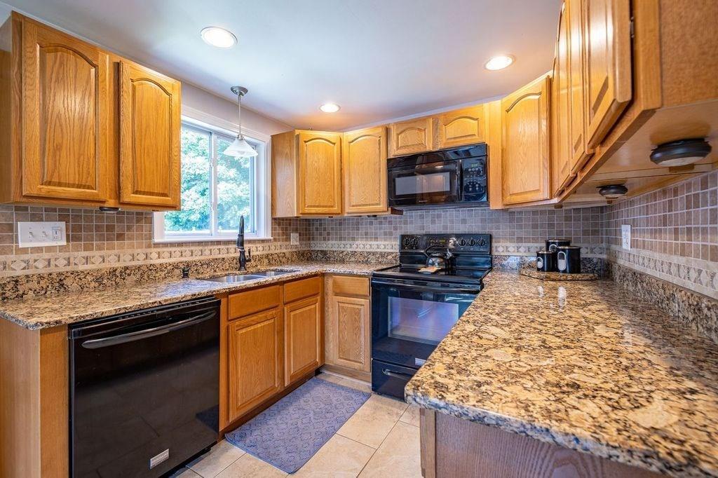 32 Maple Avenue Rutland, MA 01543 - Photo 6 of 42 a kitchen with stainless steel appliances granite countertop a stove sink and cabinets