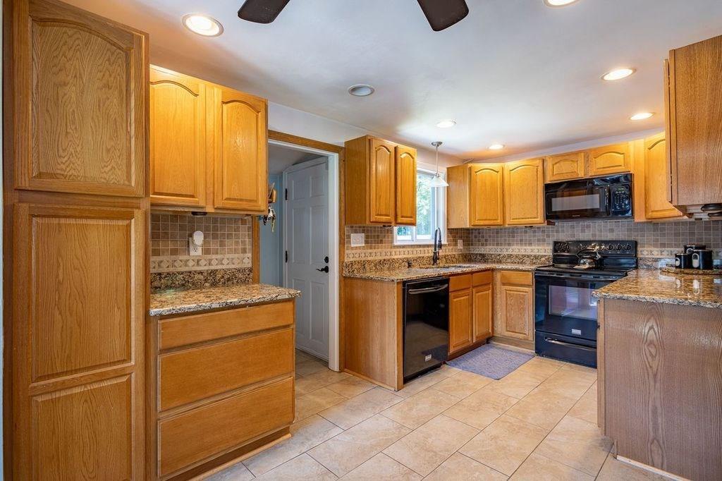 32 Maple Avenue Rutland, MA 01543 - Photo 8 of 42 a kitchen with stainless steel appliances granite countertop a refrigerator a stove and a sink with large window
