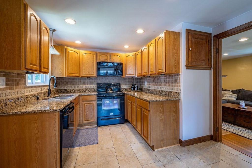 32 Maple Avenue Rutland, MA 01543 - Photo 10 of 42 a kitchen with stainless steel appliances granite countertop a stove a sink and a microwave