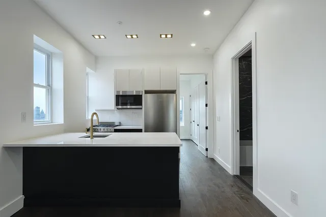 a kitchen with refrigerator and window