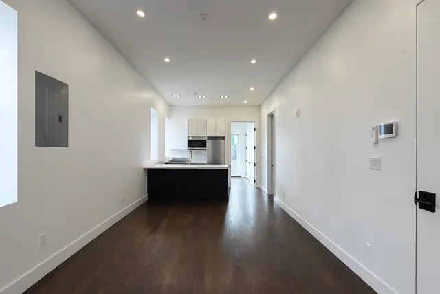 a view of kitchen with wooden floor and electronic appliances