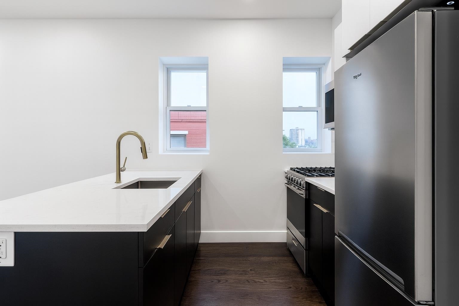 272 Hoboken Avenue, Unit 5 Jersey City, NJ 07306 - Photo 6 of 16 a kitchen with a sink and a refrigerator