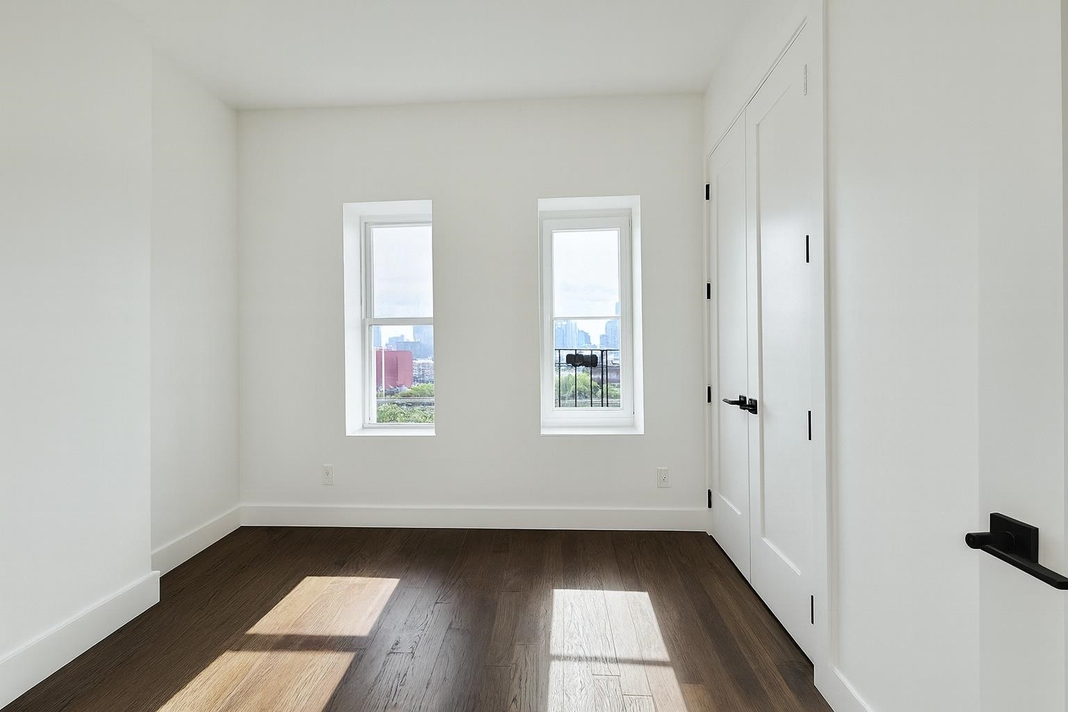272 Hoboken Avenue, Unit 5 Jersey City, NJ 07306 - Photo 8 of 16 a view of an empty room with wooden floor and a window
