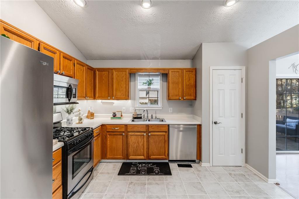 384 Springbrooke Trail Dallas, GA 30157 - Photo 11 of 31 a kitchen with a sink stove and cabinets