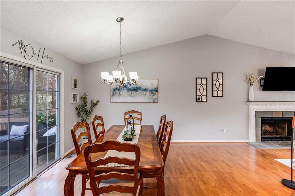 384 Springbrooke Trail Dallas, GA 30157 - Photo 14 of 31 a view of a dining room with furniture wooden floor and chandelier
