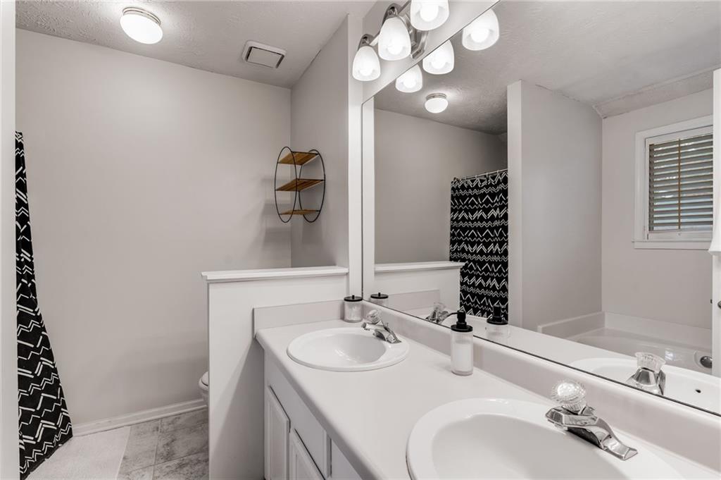 384 Springbrooke Trail Dallas, GA 30157 - Photo 21 of 31 a bathroom with a sink and a mirror