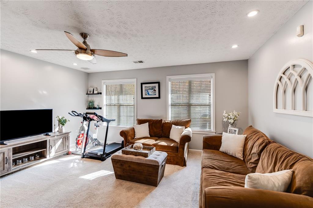 384 Springbrooke Trail Dallas, GA 30157 - Photo 23 of 31 a living room with furniture and a flat screen tv
