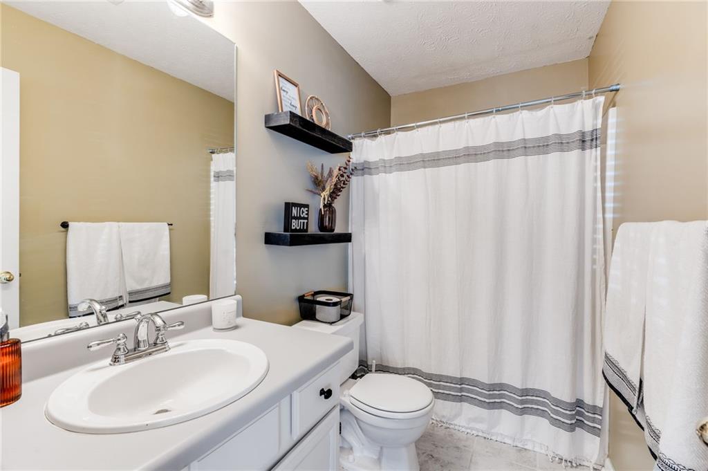 384 Springbrooke Trail Dallas, GA 30157 - Photo 24 of 31 a bathroom with a sink toilet and shower