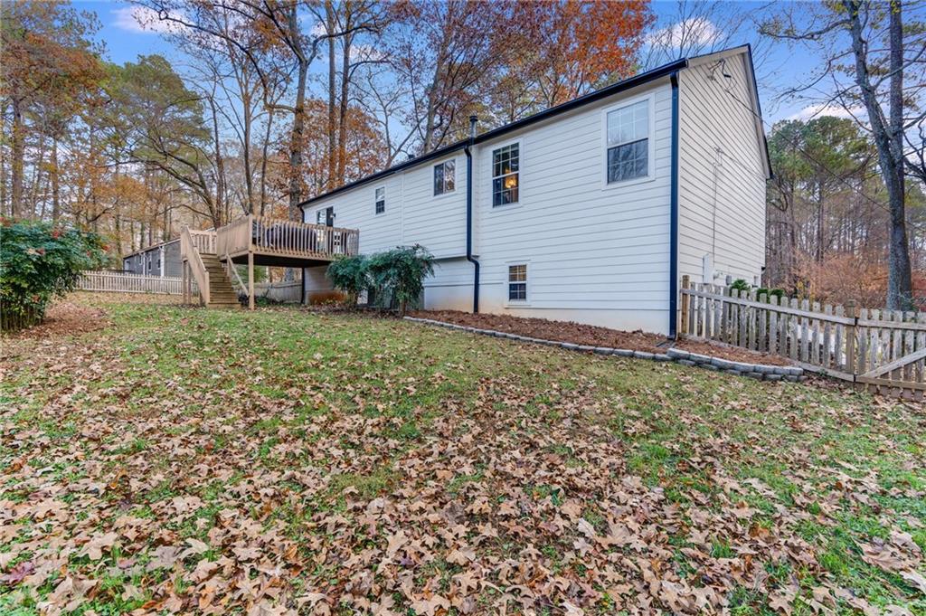 384 Springbrooke Trail Dallas, GA 30157 - Photo 30 of 31 a backyard of a house with table and chairs