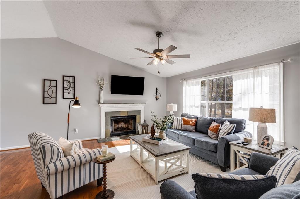 384 Springbrooke Trail Dallas, GA 30157 - Photo 8 of 31 a living room with furniture fireplace and a large window