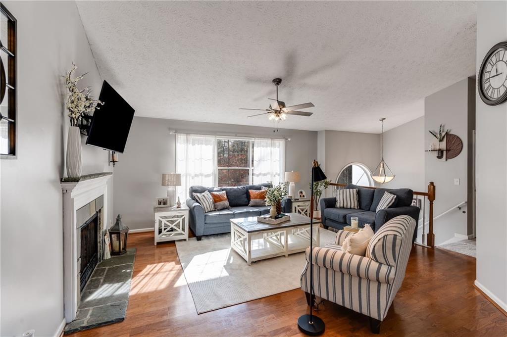 384 Springbrooke Trail Dallas, GA 30157 - Photo 9 of 31 a living room with furniture a fireplace and a flat screen tv