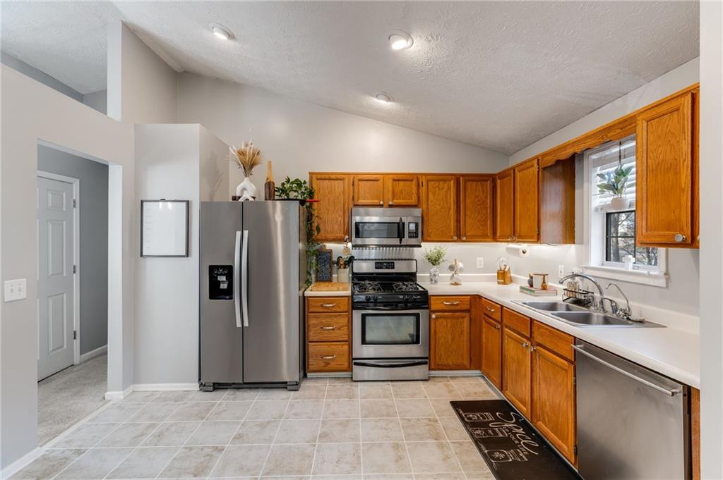 384 Springbrooke Trail Dallas, GA 30157 - Photo 10 of 31 a kitchen with stainless steel appliances granite countertop a refrigerator stove and sink