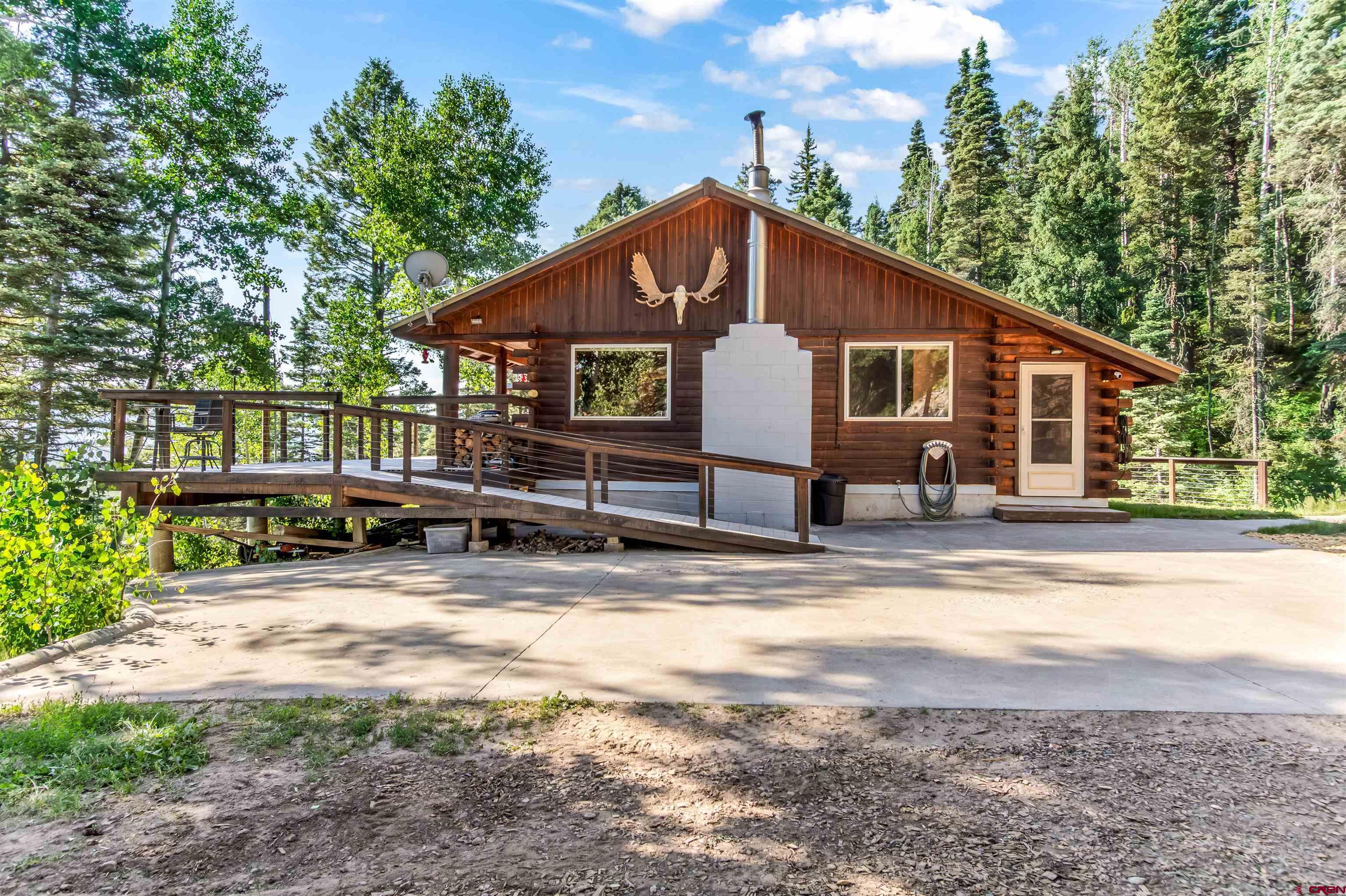 504 Weminuche Road Pagosa Springs, CO 81147 - Photo 22 of 44 a view of a house with backyard and sitting area