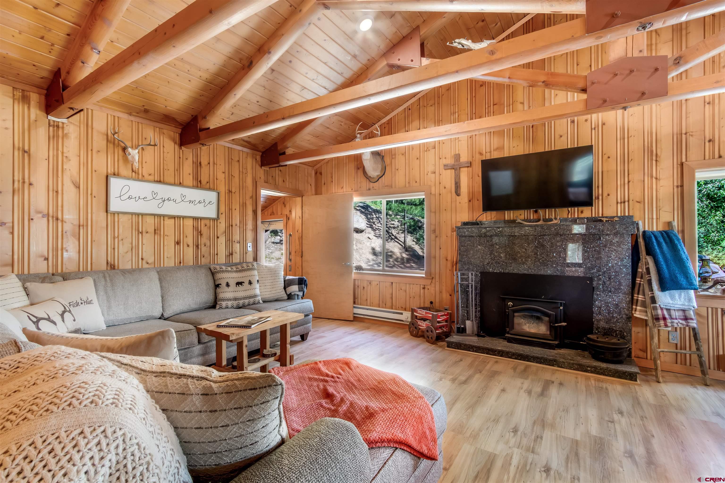 504 Weminuche Road Pagosa Springs, CO 81147 - Photo 30 of 44 a living room with furniture and a fireplace