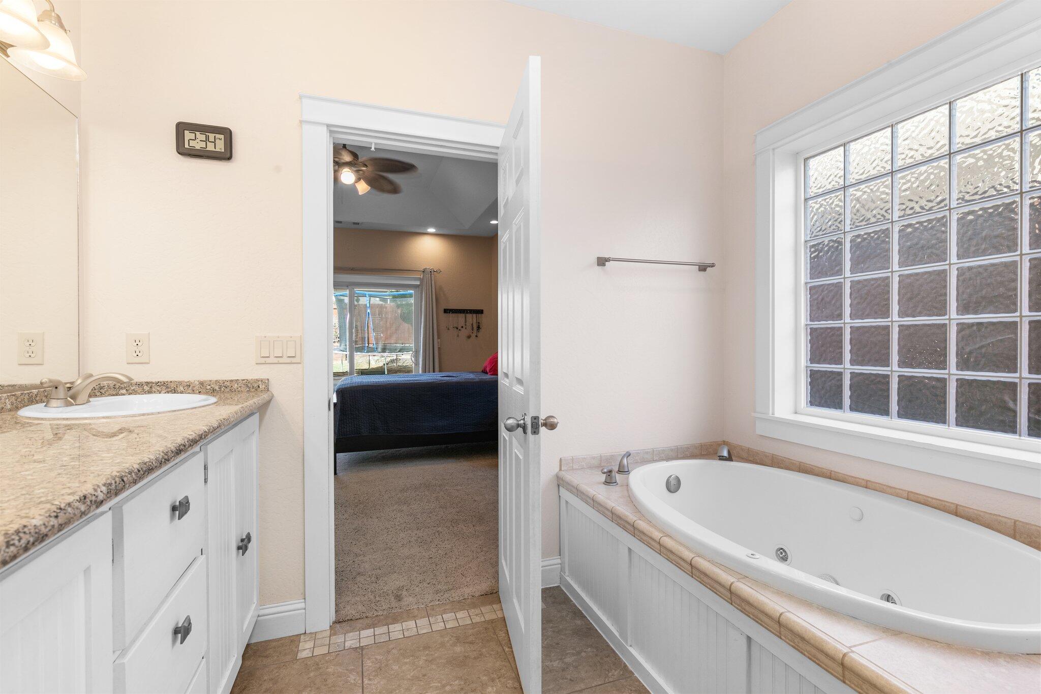 1965 Rabun Way Central Point, OR 97502 - Photo 27 of 47 a bathroom with a granite countertop tub sink and mirror