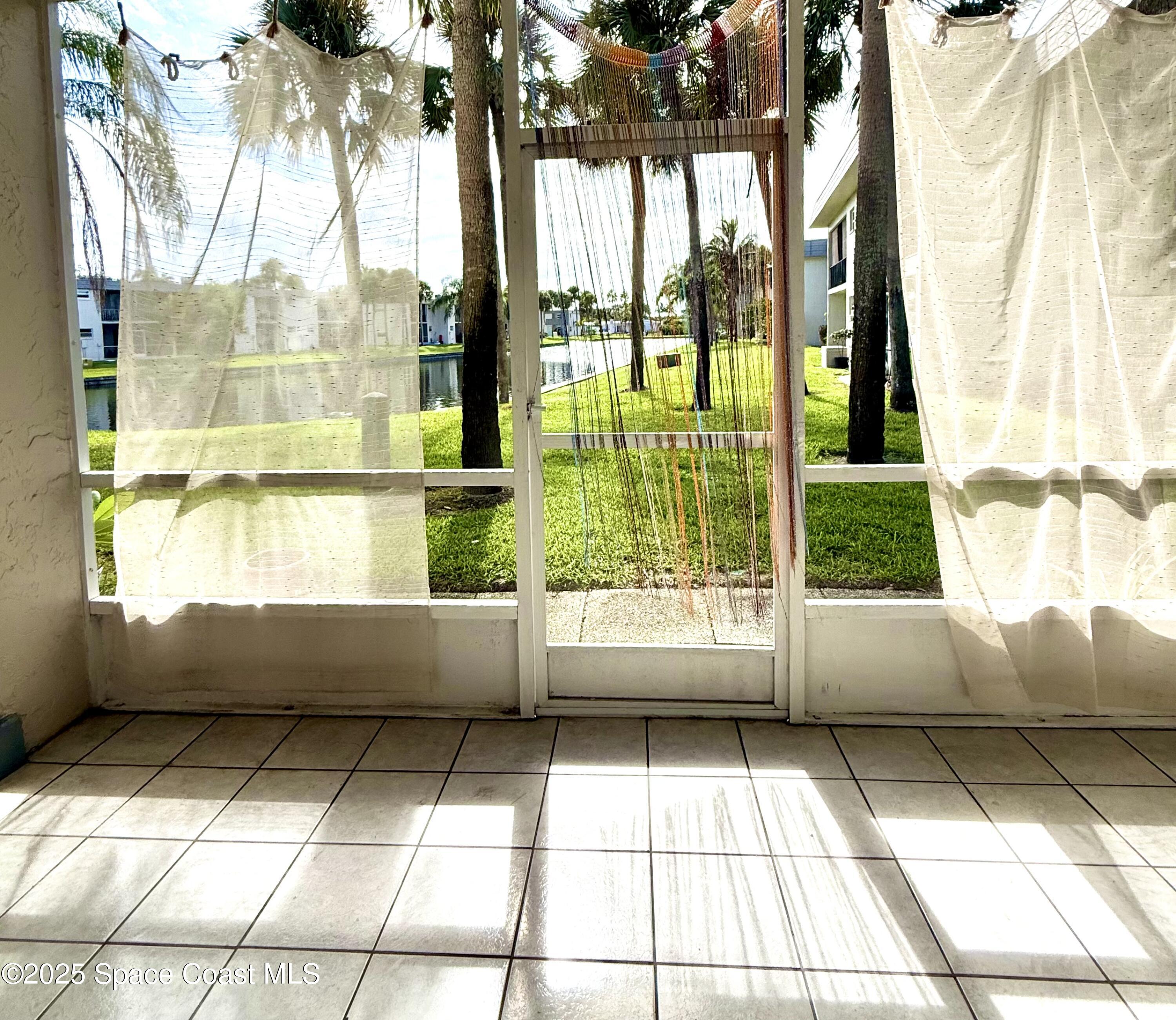 417 Ibis Lane, Unit 96 Satellite Beach, FL 32937 - Photo 11 of 29 a bathroom with a bathtub and window