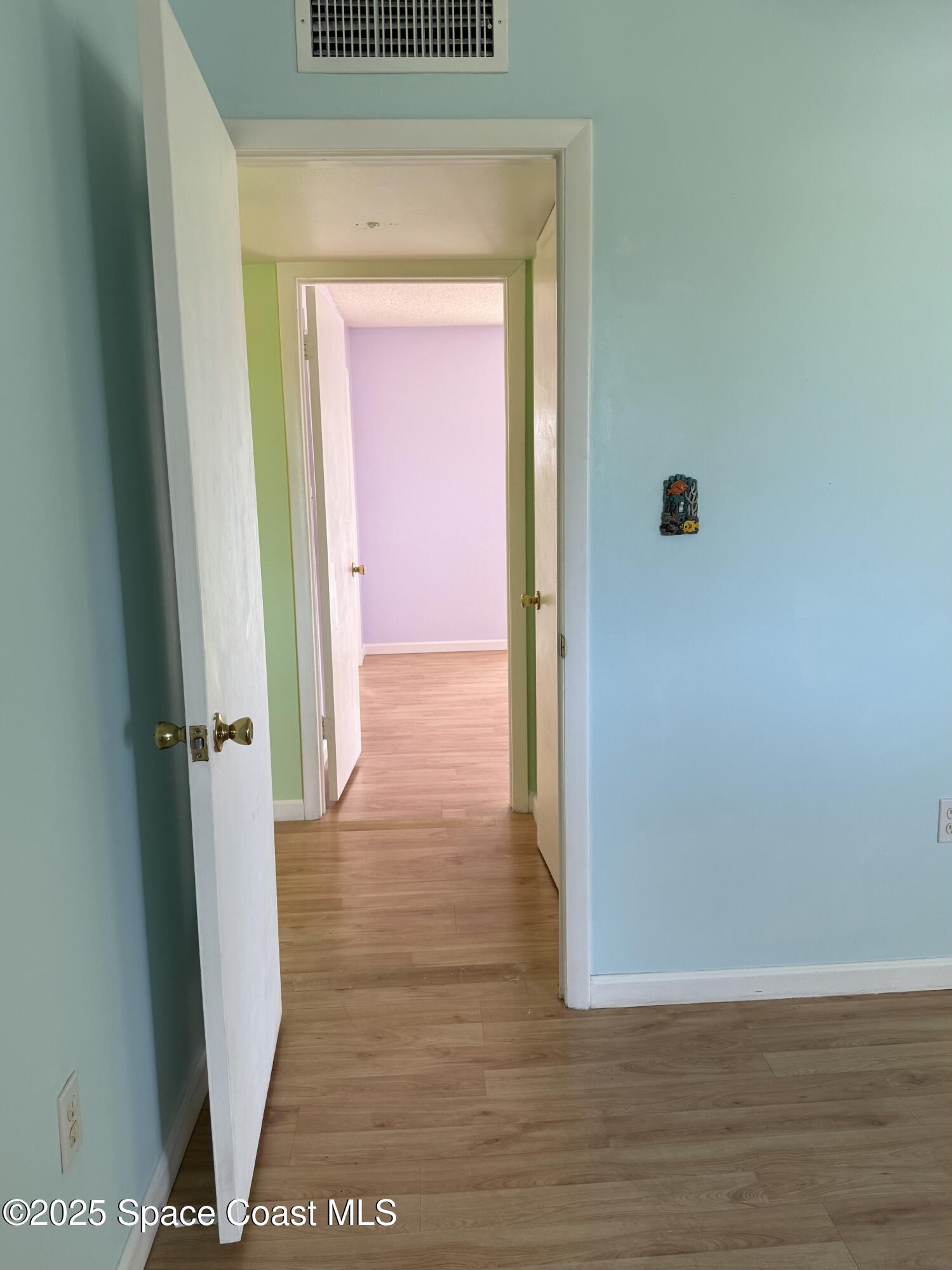 417 Ibis Lane, Unit 96 Satellite Beach, FL 32937 - Photo 16 of 29 a view of a hallway with wooden floor