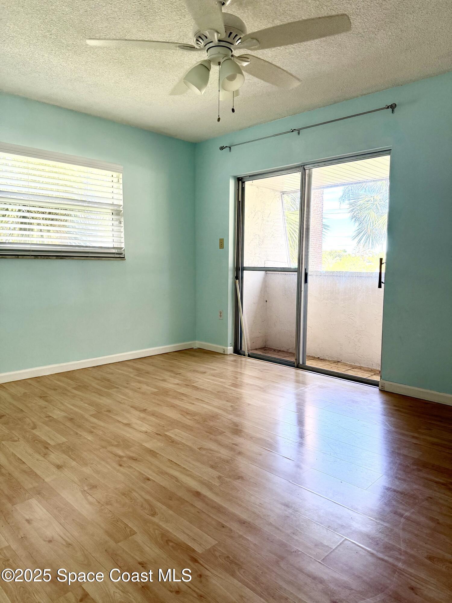 417 Ibis Lane, Unit 96 Satellite Beach, FL 32937 - Photo 17 of 29 a view of an empty room with wooden floor and a window