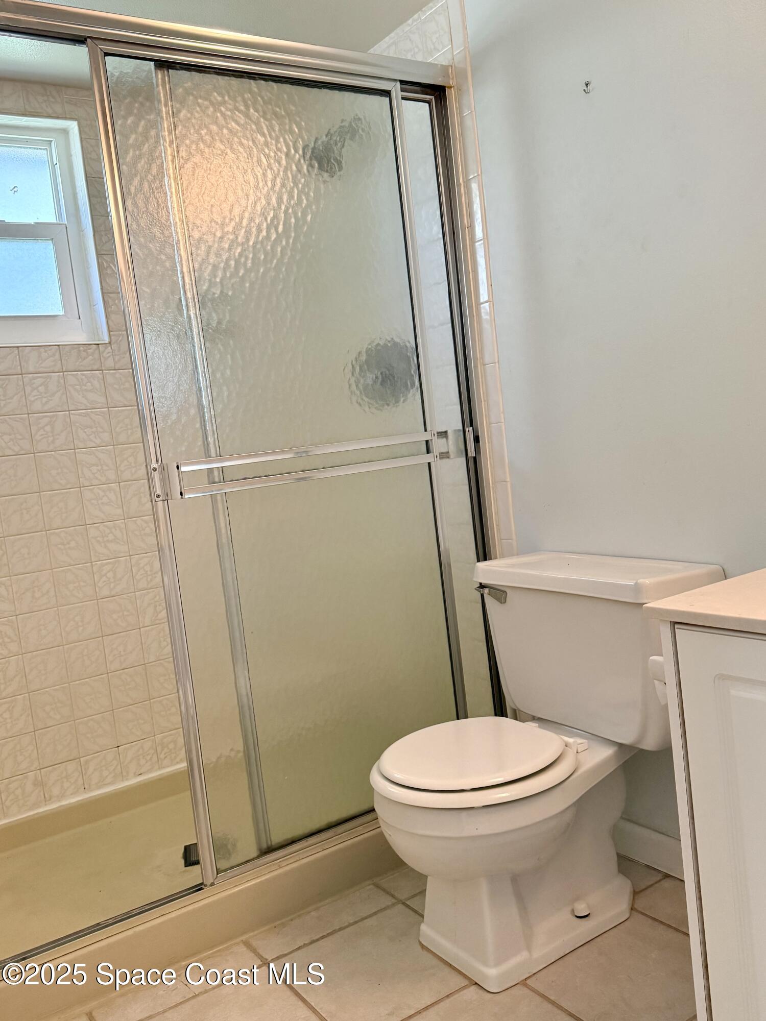 417 Ibis Lane, Unit 96 Satellite Beach, FL 32937 - Photo 19 of 29 a white toilet sitting next to a shower