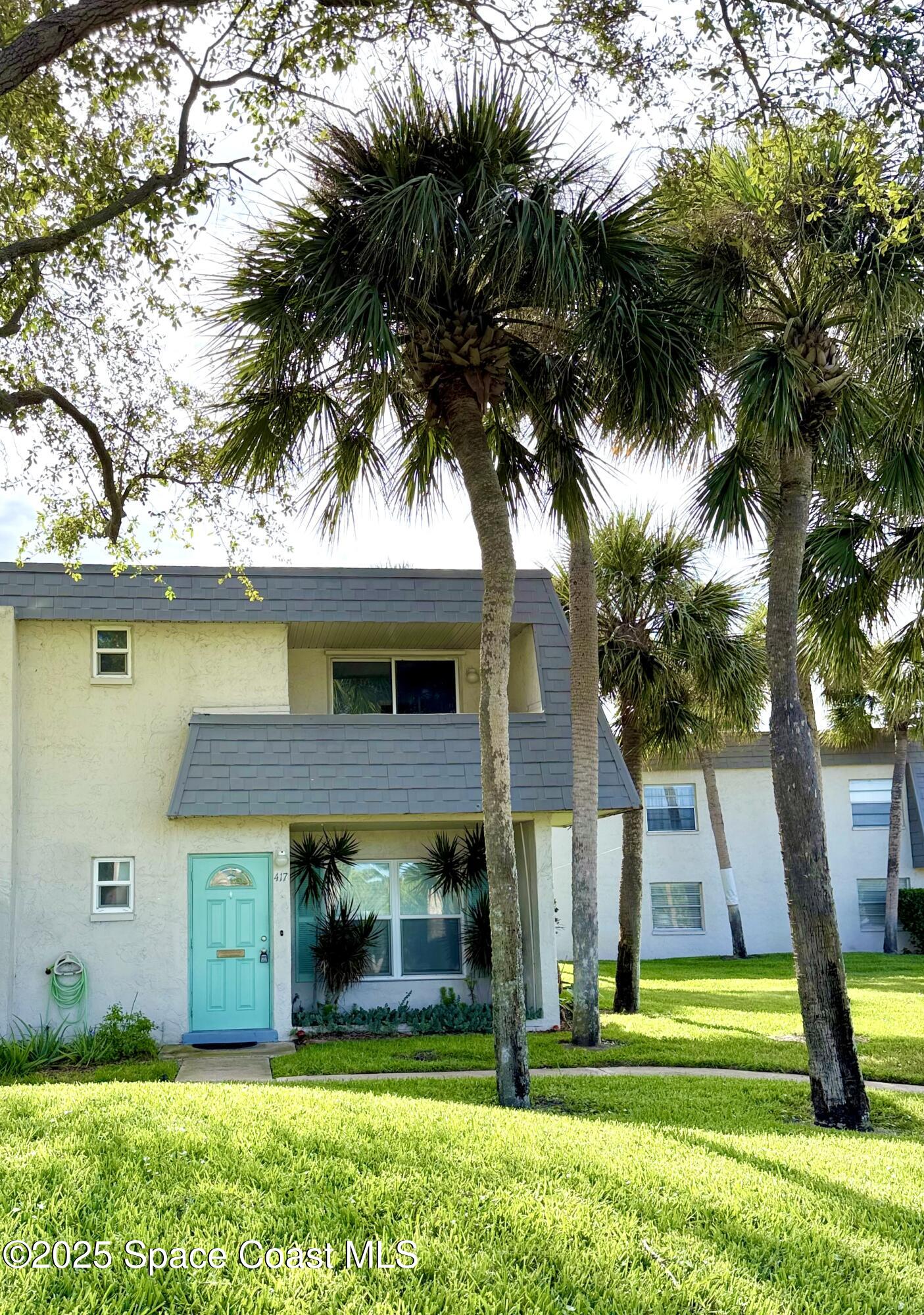 417 Ibis Lane, Unit 96 Satellite Beach, FL 32937 - Photo 2 of 29 a view of a house with a yard