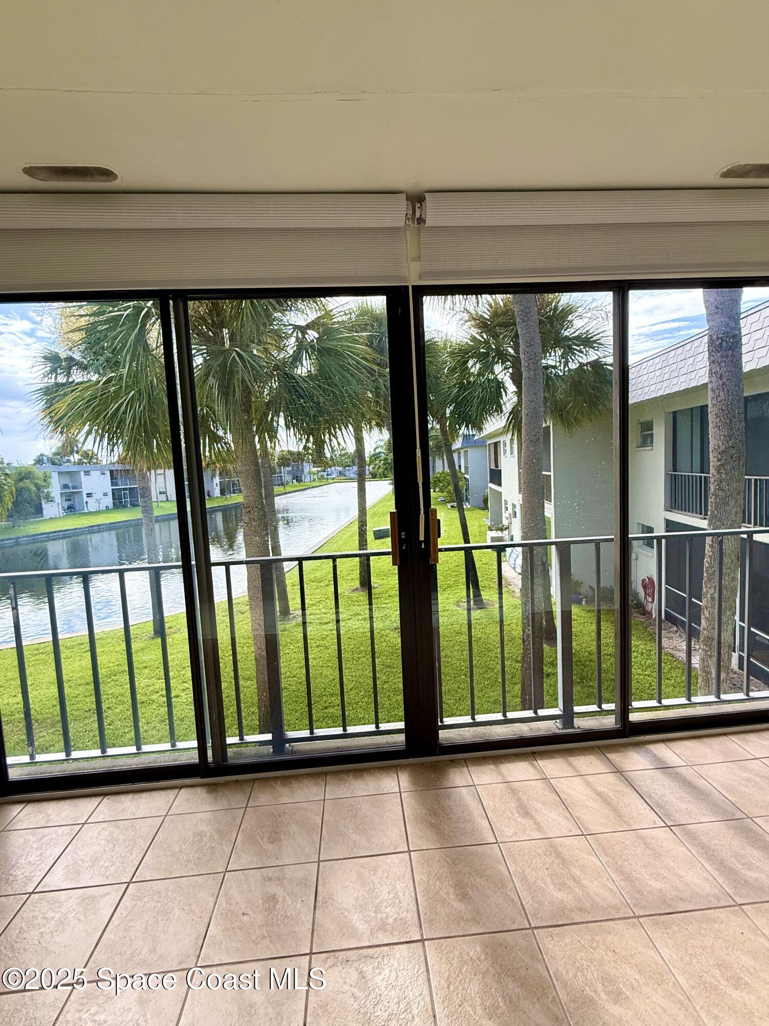 417 Ibis Lane, Unit 96 Satellite Beach, FL 32937 - Photo 26 of 29 a view of a room with large windows and plants