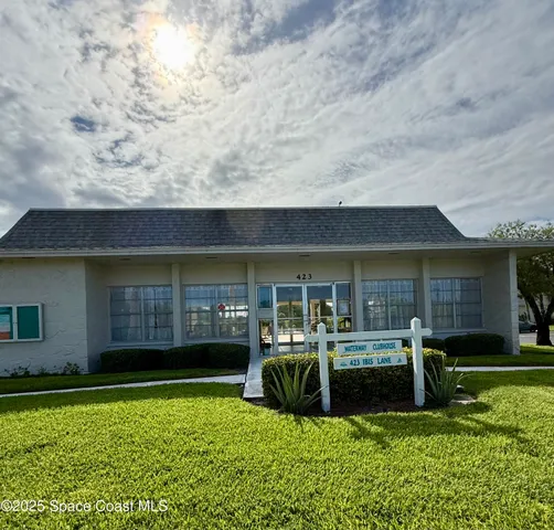 a view of a house with backyard porch and sitting area