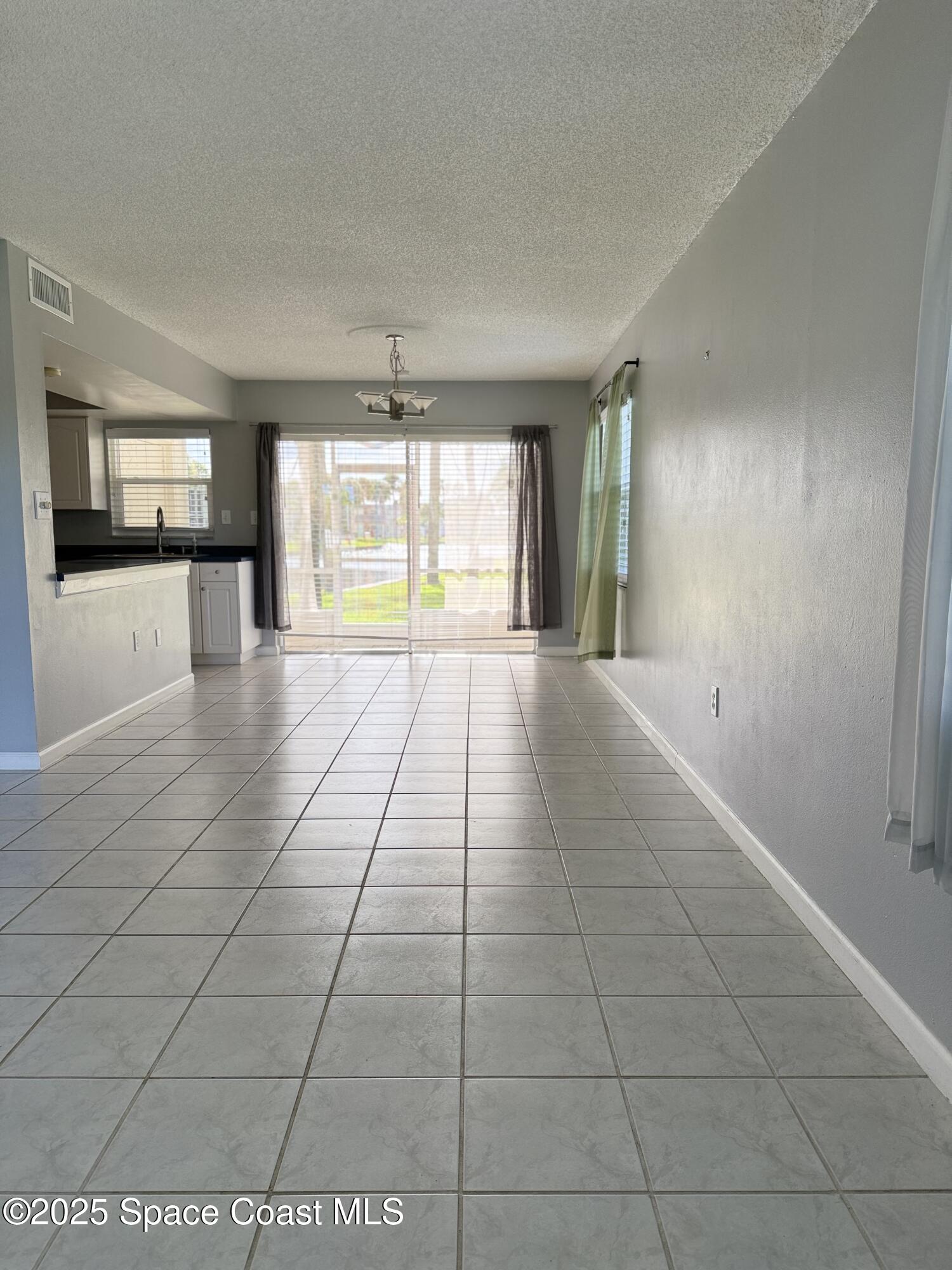 417 Ibis Lane, Unit 96 Satellite Beach, FL 32937 - Photo 7 of 29 a view of an empty room and window
