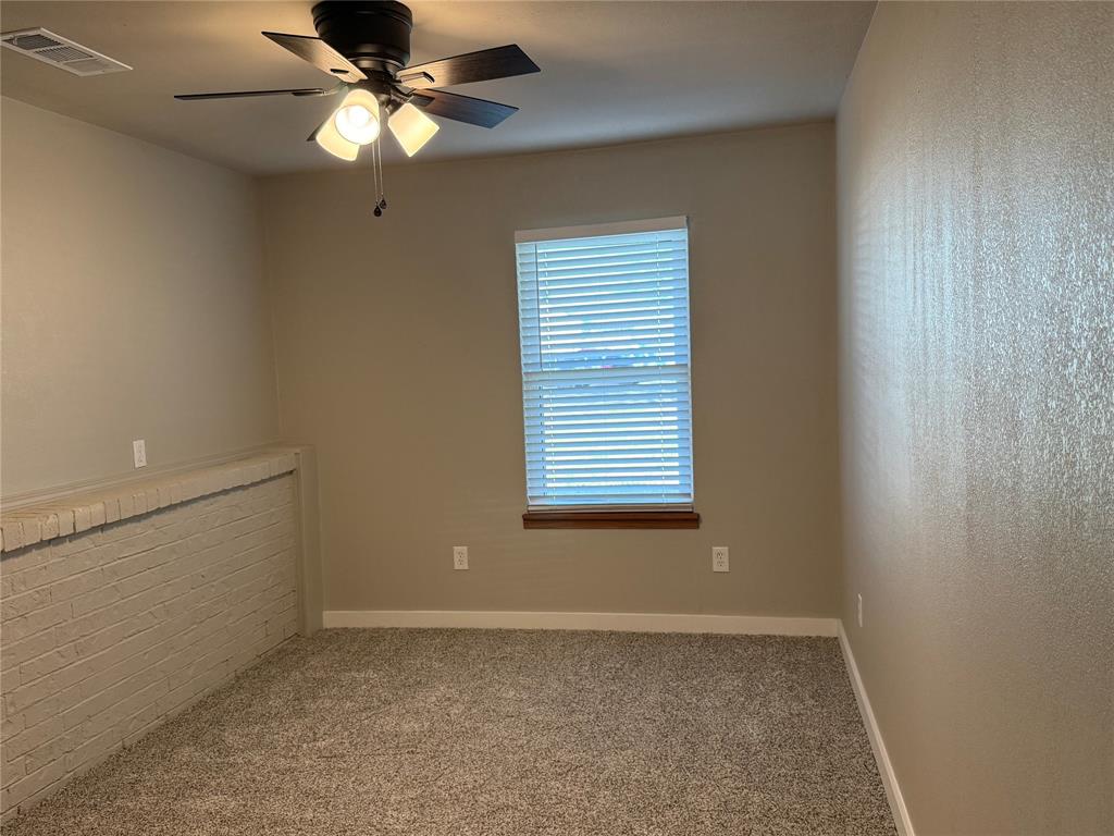10109 Clark Airfield Road Justin, TX 76247 - Photo 17 of 24 The second bedroom downstairs. All windows in the home are new with new blinds.