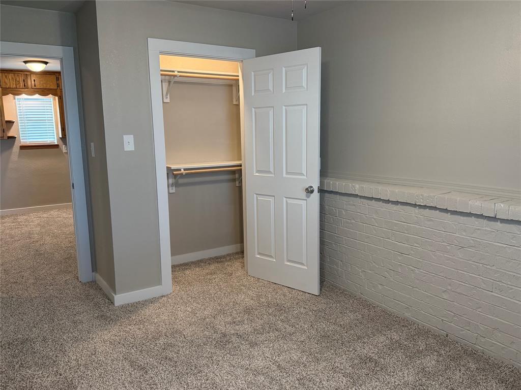 10109 Clark Airfield Road Justin, TX 76247 - Photo 18 of 24 Another angle on the second downstairs bedroom. You can see the closet and the downstairs bonus area beyond.