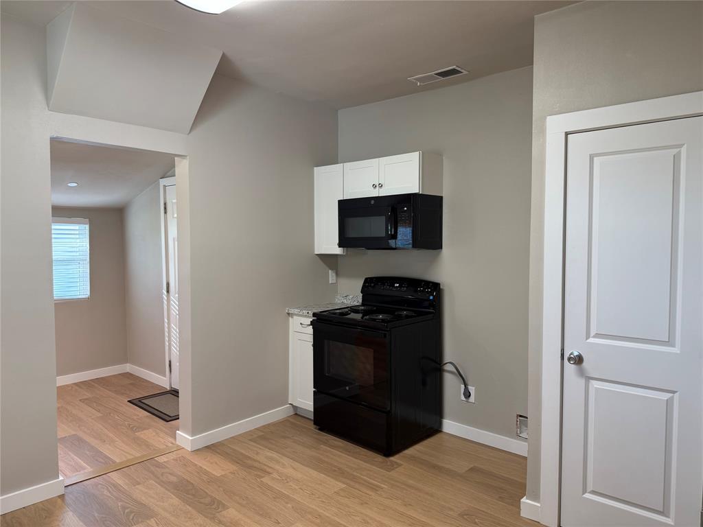 10109 Clark Airfield Road Justin, TX 76247 - Photo 6 of 24 New range and microwave - nice pantry. You can see the laundry room from here.