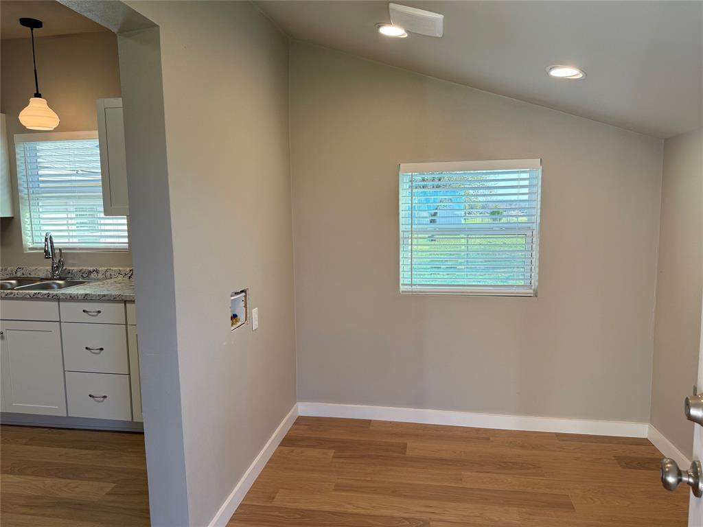 10109 Clark Airfield Road Justin, TX 76247 - Photo 7 of 24 A sunny laundry room with space for a mud bench! The central part of this house was an old home moved here years ago from Fort Worth. The laundry room was originally the backporch of the little house. It makes a CUTE laundry room!