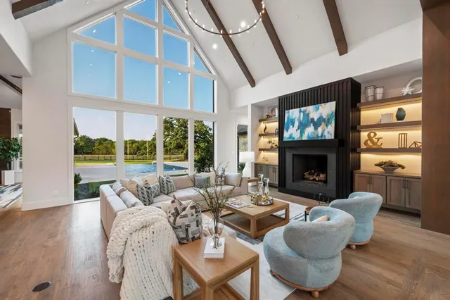 a living room with furniture a fireplace and a flat screen tv