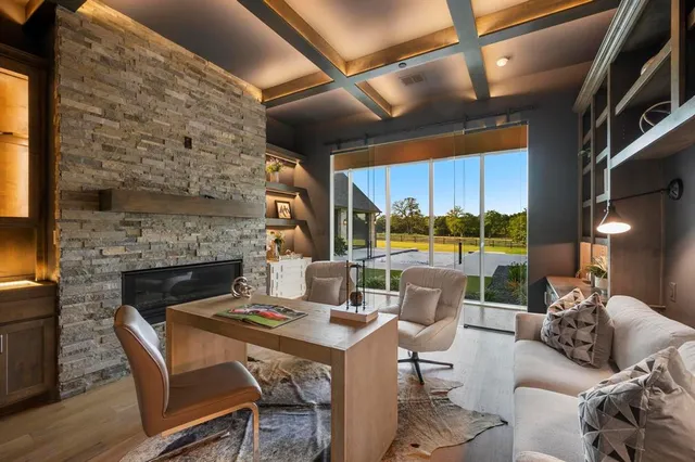 a dining room with furniture a fireplace and wooden floor