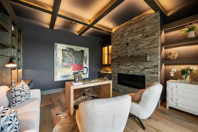 a living room with furniture mirror on the wall and a fireplace