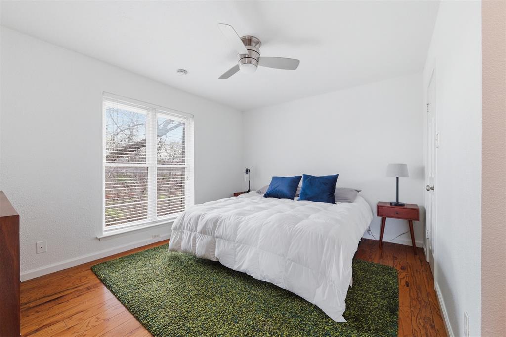 4837 Cedar Springs Road, Unit 311 Dallas, TX 75219 - Photo 13 of 17 Bedroom featuring wood-type flooring and a ceiling fan
