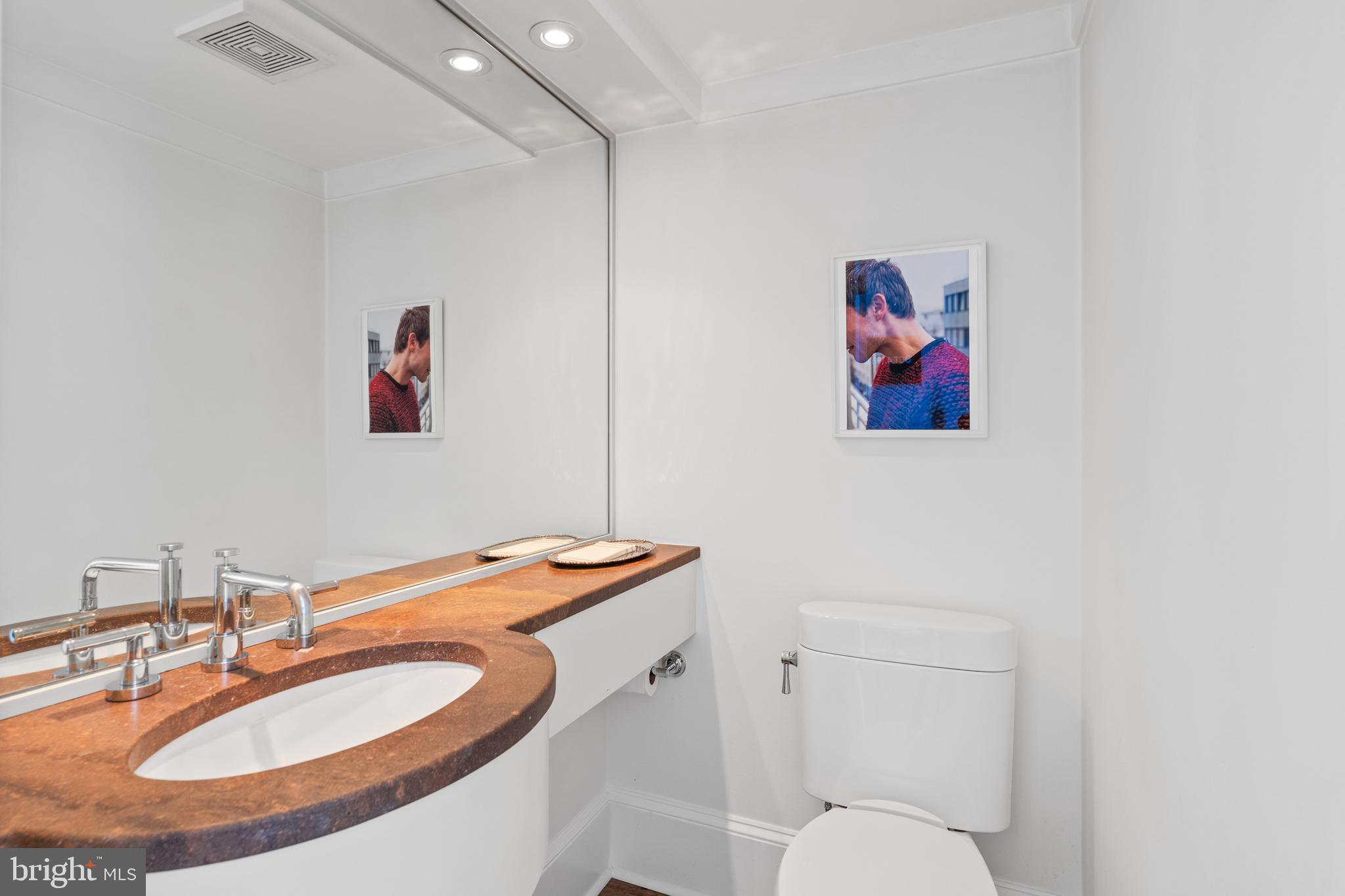 1341 Q Street Northwest, Unit B Washington, DC 20009 - Photo 11 of 31 a bathroom with a sink and a mirror