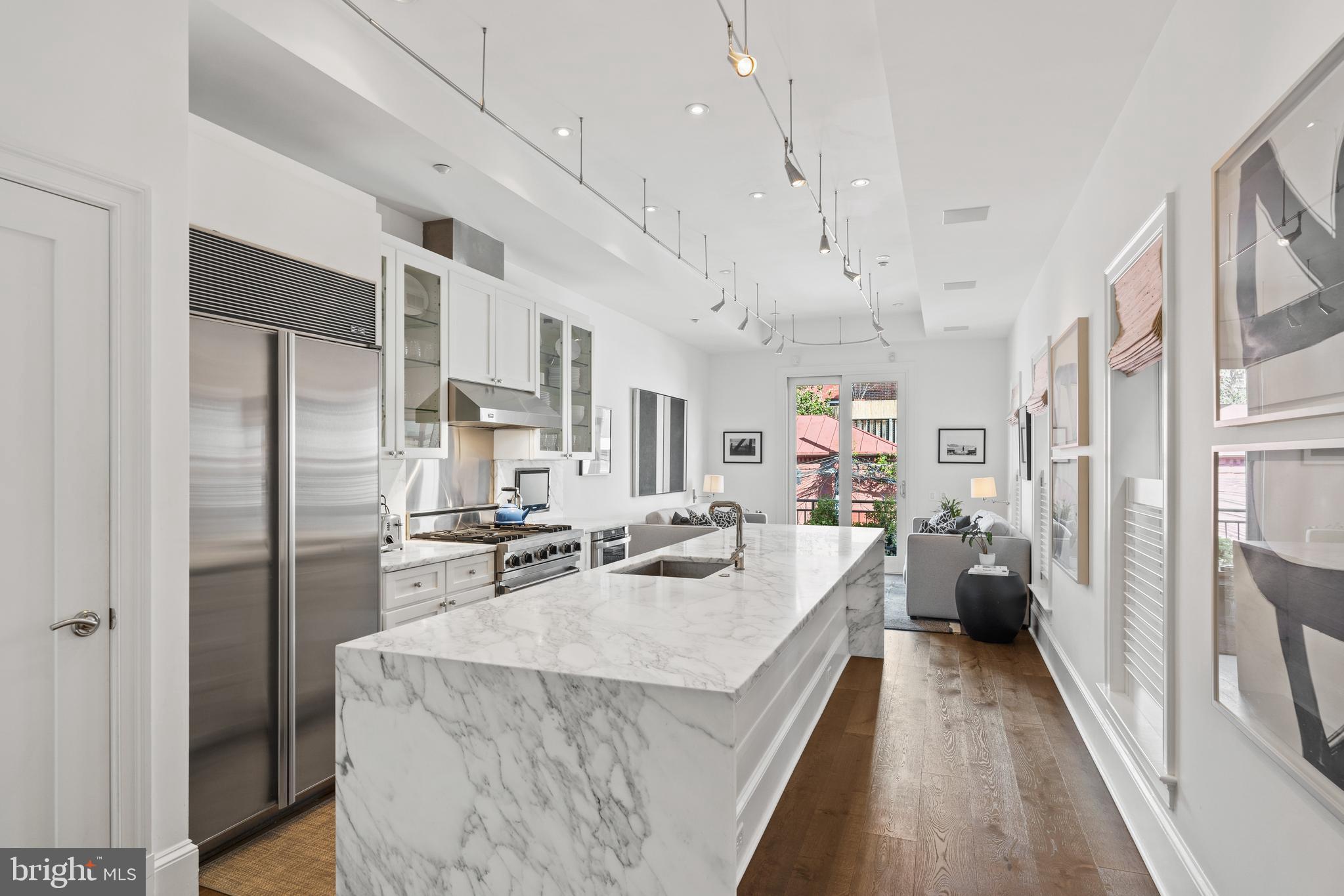 1341 Q Street Northwest, Unit B Washington, DC 20009 - Photo 7 of 31 a kitchen with kitchen island a refrigerator stove and sink
