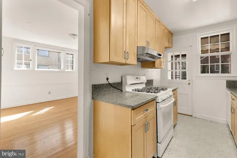 a kitchen with stainless steel appliances granite countertop a stove and a sink