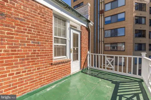 a view of a brick house with a yard