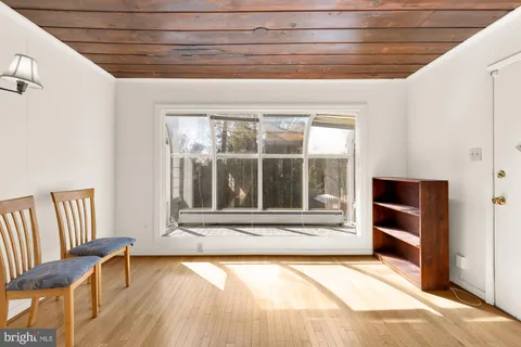 a view of an empty room with a fireplace and a window
