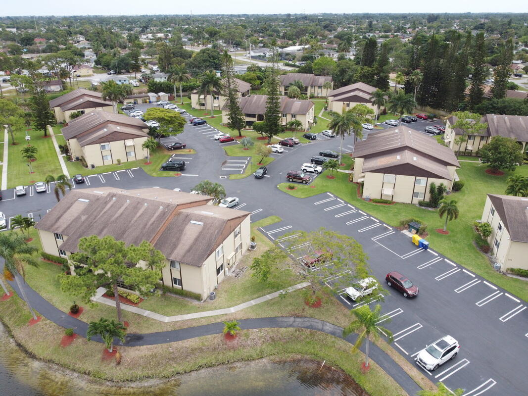 320 Pine Ridge Circle, Unit A1 Greenacres, FL 33463 - Photo 62 of 65 an aerial view of residential houses with outdoor space