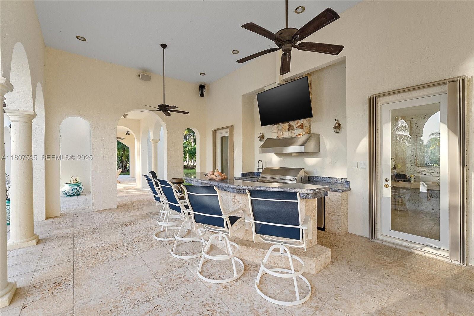 18451 Southwest 158th Street Miami, FL 33187 - Photo 12 of 45 a view of a dining room with furniture a fireplace and a chandelier