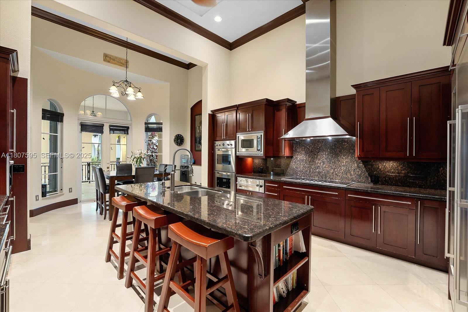18451 Southwest 158th Street Miami, FL 33187 - Photo 15 of 45 a kitchen with stainless steel appliances granite countertop a stove a sink dishwasher and cabinets with wooden floor