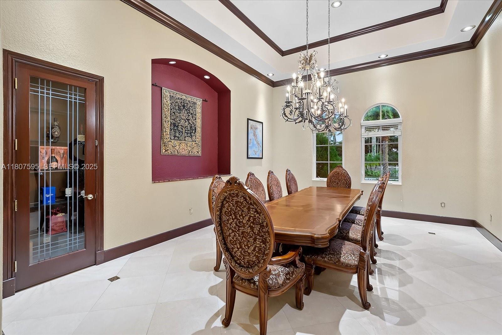 18451 Southwest 158th Street Miami, FL 33187 - Photo 17 of 45 a view of a dining room with furniture and chandelier