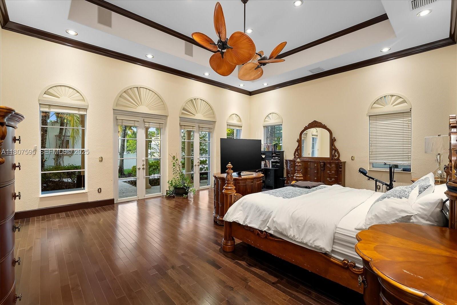 18451 Southwest 158th Street Miami, FL 33187 - Photo 22 of 45 a bedroom with a bed ceiling fan and a large window