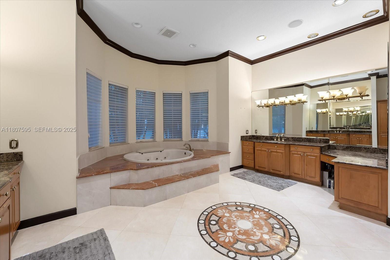 18451 Southwest 158th Street Miami, FL 33187 - Photo 24 of 45 a spacious bathroom with a tub double vanity sink and a mirror