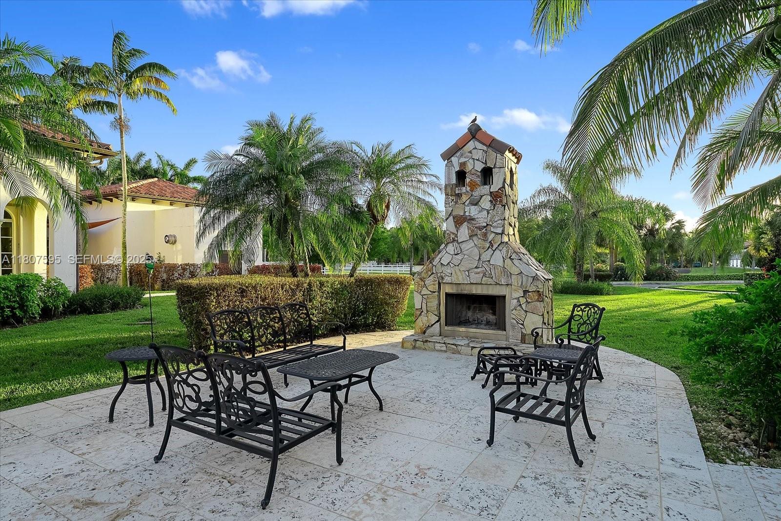 18451 Southwest 158th Street Miami, FL 33187 - Photo 33 of 45 a view of a dinning table and chairs in the garden